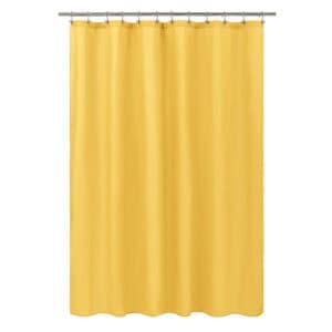 Mustard yellow shower curtain hanging on a rod