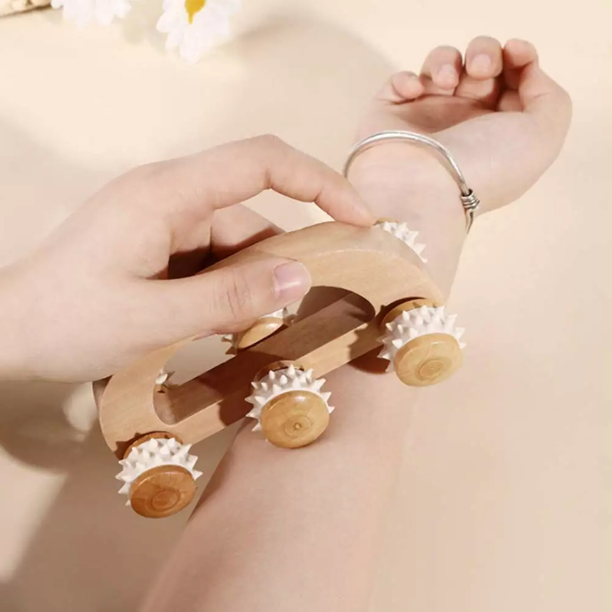 Hand using wooden massage roller on arm for relaxation