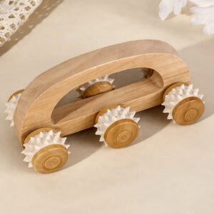 Wooden six-wheel massage roller on table with decorative setup