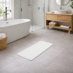 White memory foam runner mat placed beside bathtub