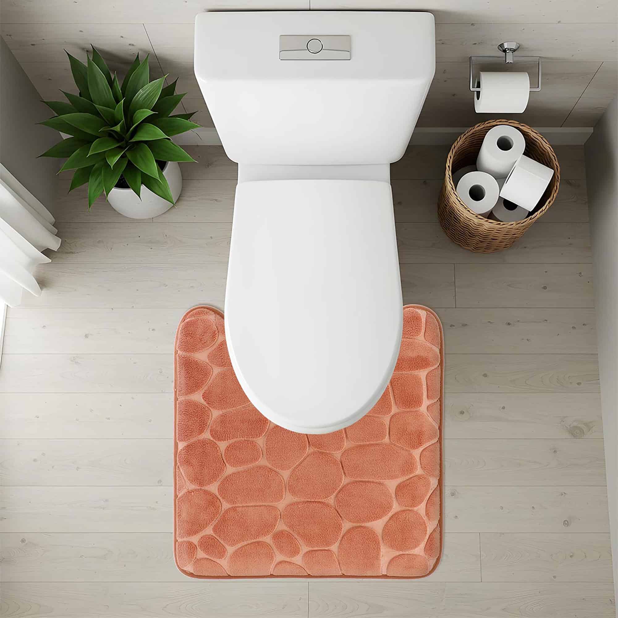 Top-down view of copper pebble-texture contour mat fitted around toilet base