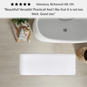 White memory foam runner mat placed beside bathtub in spa-style bathroom with customer review highlighting versatility and size