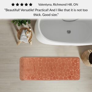 Copper memory foam runner mat placed beside bathtub in spa-style bathroom with customer review highlighting versatility and size