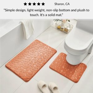 Copper contour and standard memory foam mats with pebble design positioned around toilet with slippers and customer review overlay