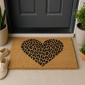 Leopard heart coir doormat placed at dark door with plants and sneakers