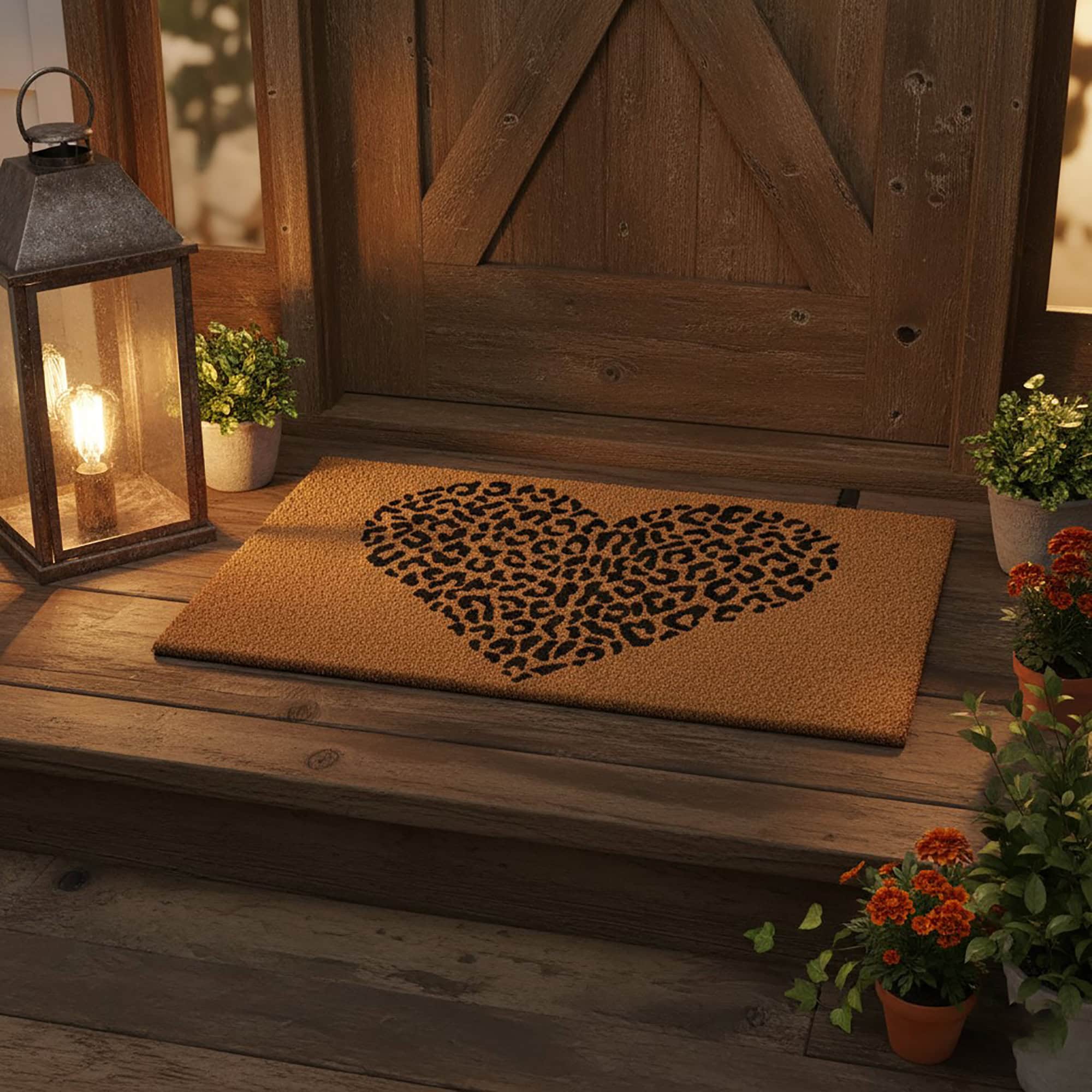Leopard heart doormat on rustic wood porch with lantern and potted flowers