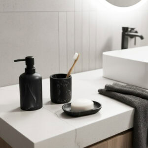 Black marble soap dispenser with black pump on modern sink vanity