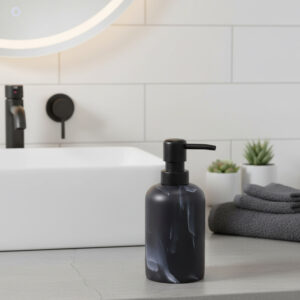 Black marble soap dispenser with black pump styled with towels and plants