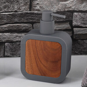 Gray soap dispenser with acacia front panel on countertop, front angle view