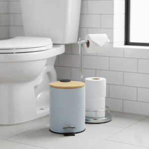 Light blue step trash can with bamboo lid next to toilet