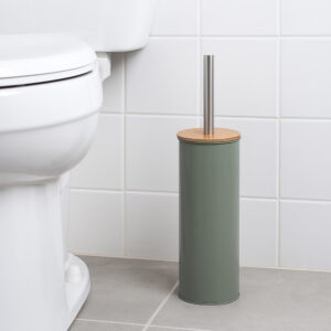 "Green toilet brush holder with bamboo lid and steel handle beside white toilet"