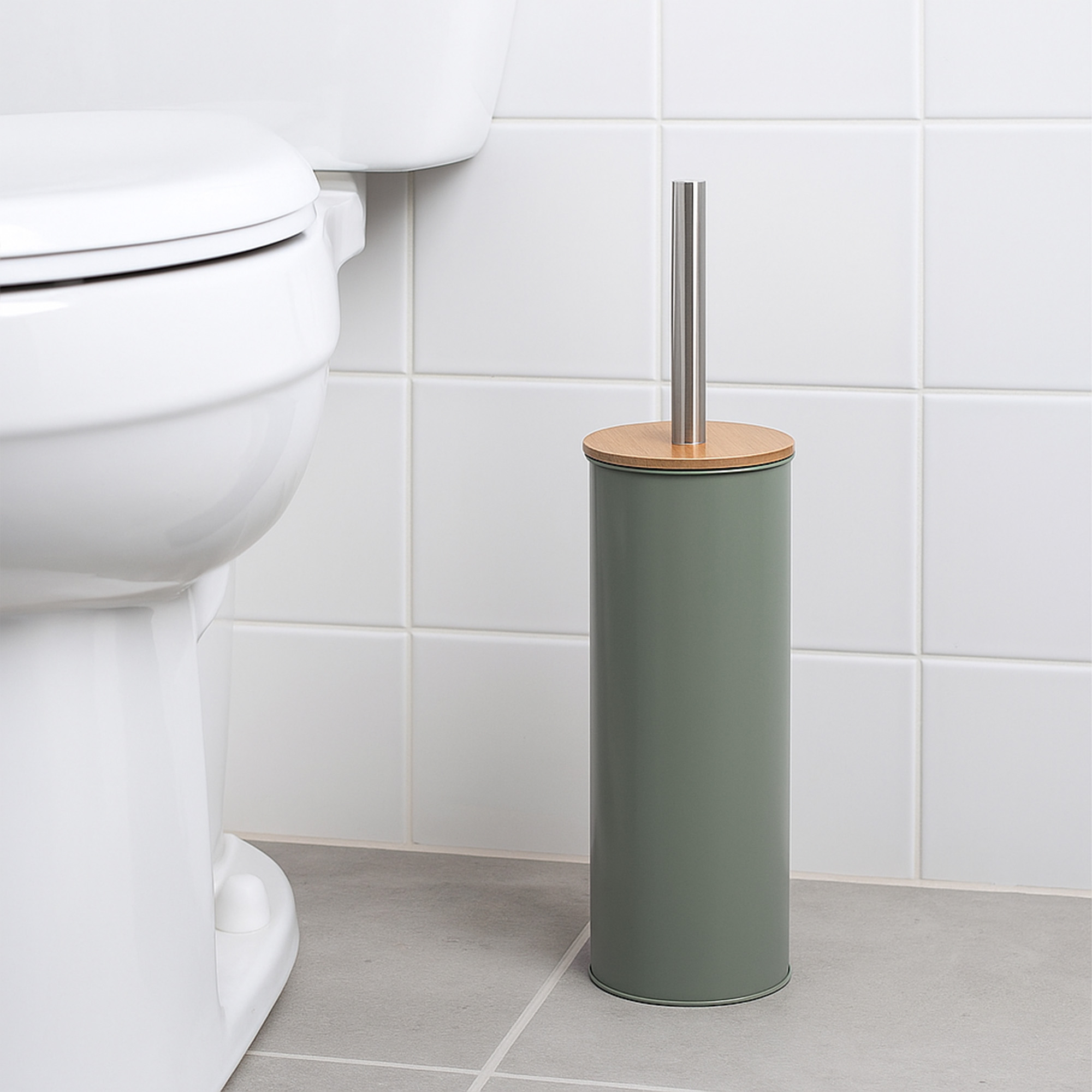 "Green toilet brush holder with bamboo lid and steel handle beside white toilet"