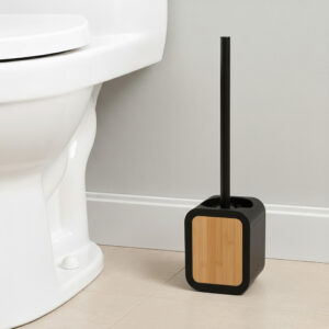 Black toilet brush holder with bamboo insert and black handle beside white toilet