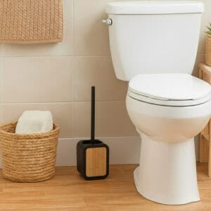 Black toilet brush holder with bamboo accent in modern bathroom with woven basket