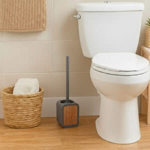 Gray toilet brush holder with acacia wood accent in modern bathroom with woven basket