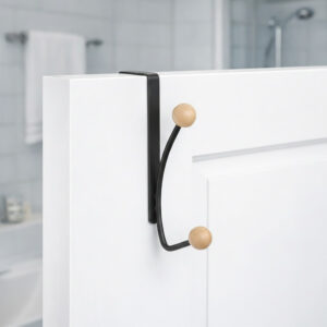 "Matte black double hook with wood ball ends mounted on white bathroom door"