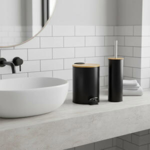 Black trash can and toilet brush with bamboo lids on bathroom counter