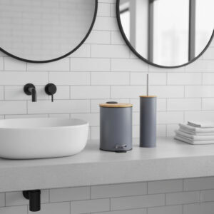 Green trash can and toilet brush with bamboo lids on bathroom counter