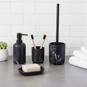 Black marble bathroom accessory set with black pump and brush handle, including tumbler, dispenser, soap dish, and toilet brush on countertop