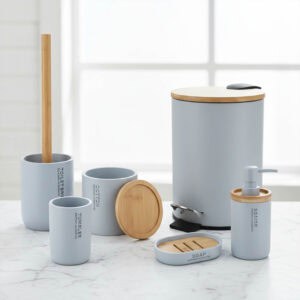 Light blue bathroom accessory set with bamboo accents on marble counter