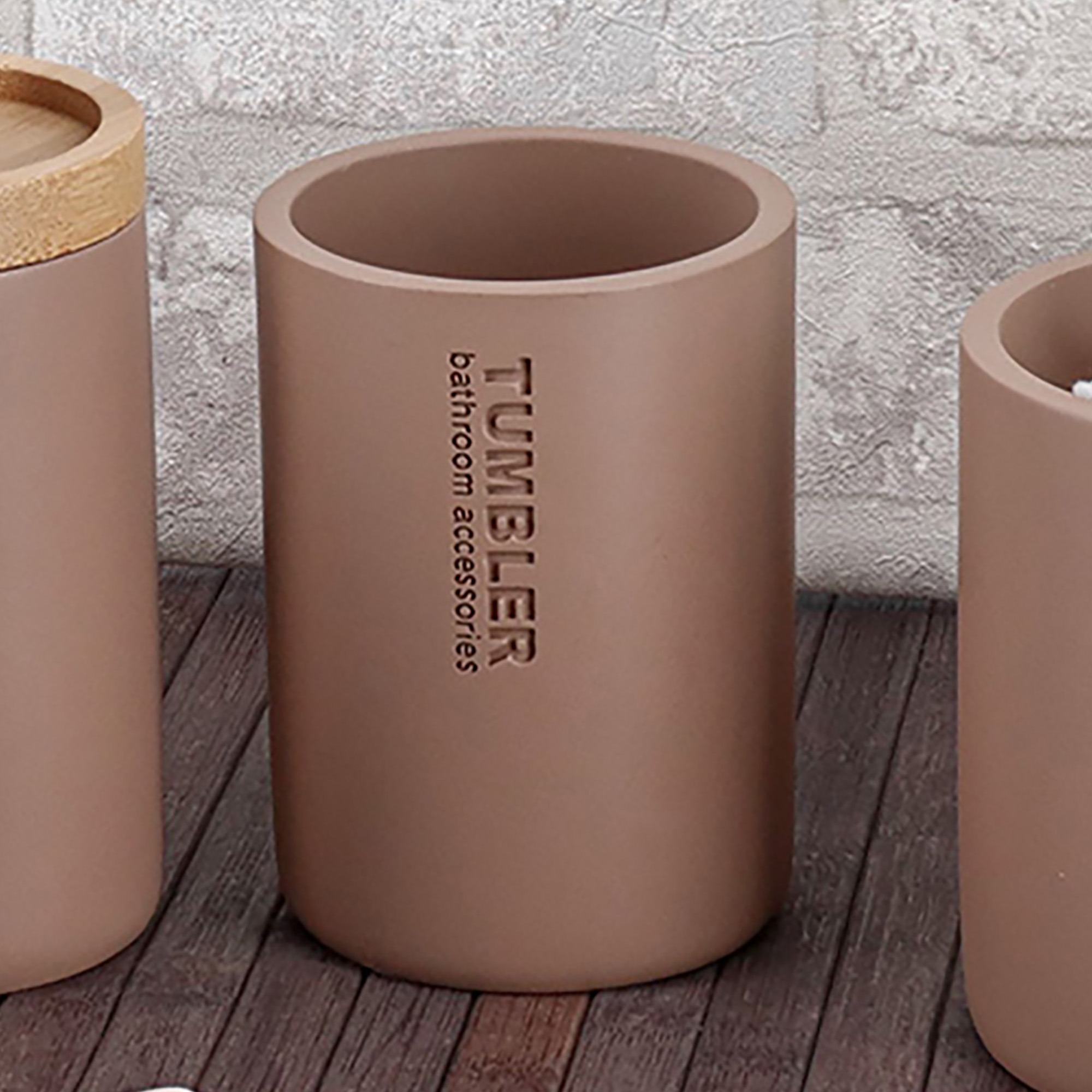 Toothbrush holder tumbler cup on bathroom countertop with toothbrush