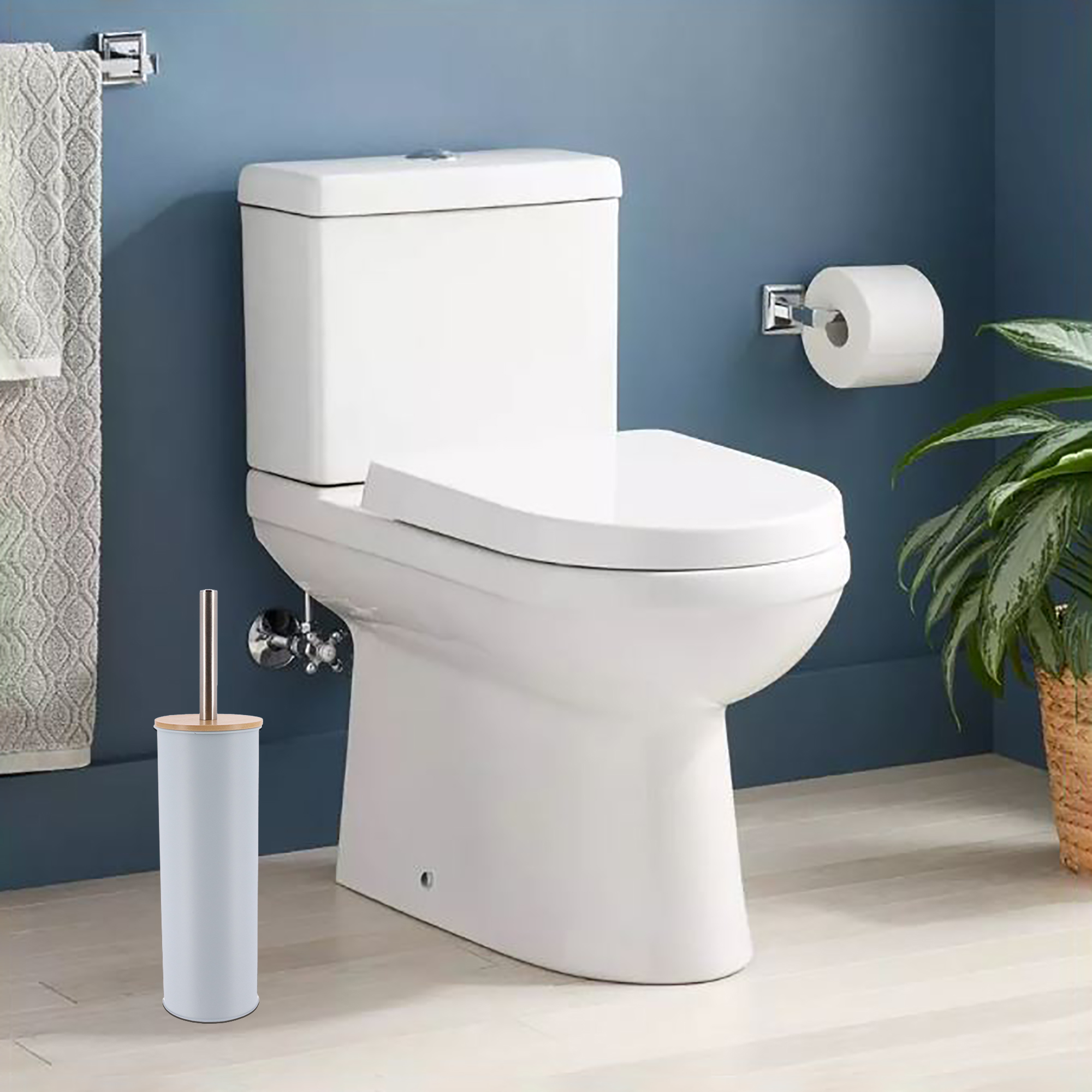 Light blue toilet brush placed in clean bathroom with blue walls, next to white toilet
