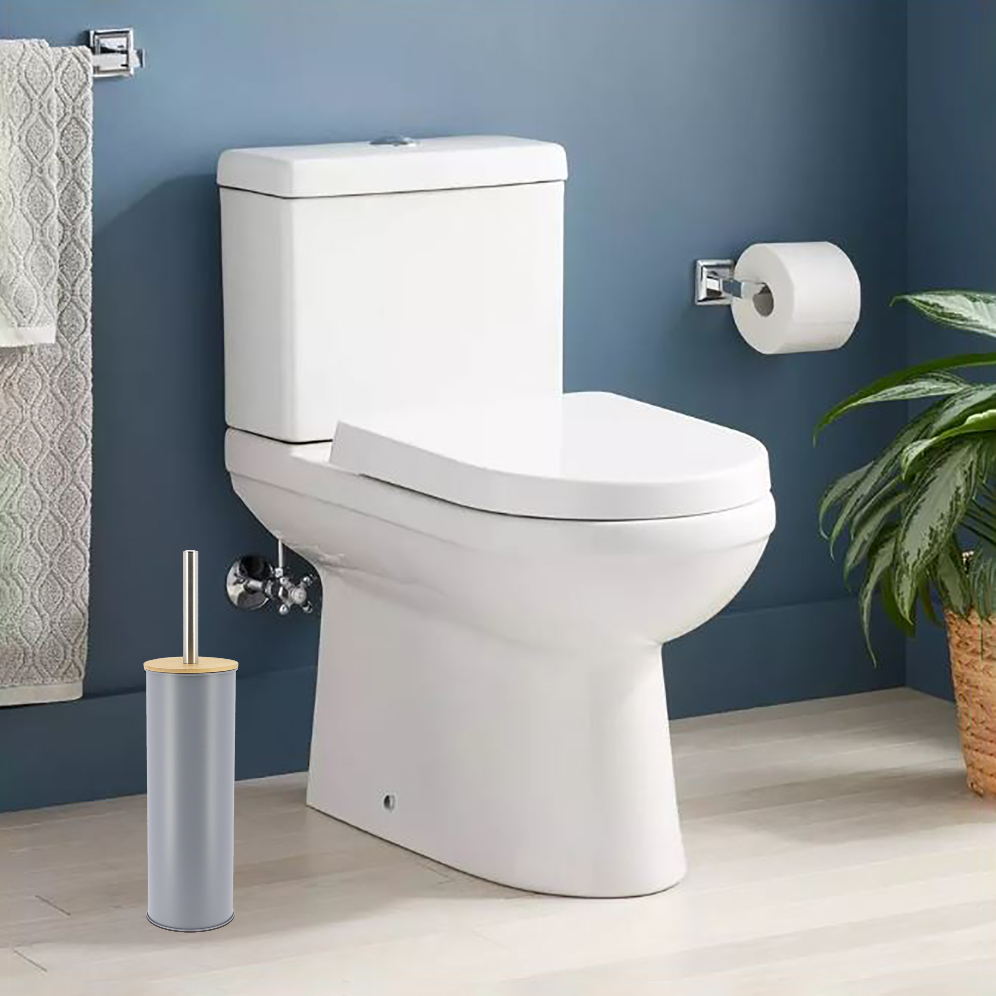 Gray toilet brush placed in clean bathroom with blue walls, next to white toilet