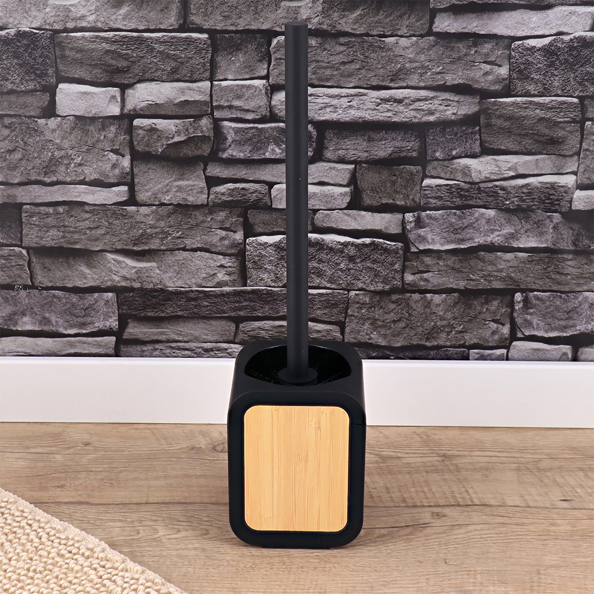 Black and bamboo toilet brush set displayed in a modern bathroom