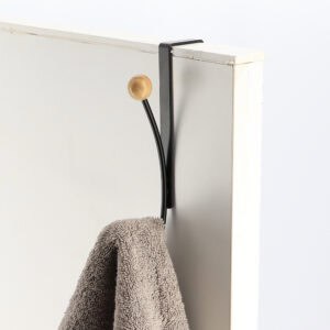 "Matte black over-the-door hook holding gray towel on white door"