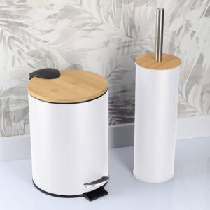 White bathroom trash bin and toilet brush holder in a modern bathroom with a patterned wall background