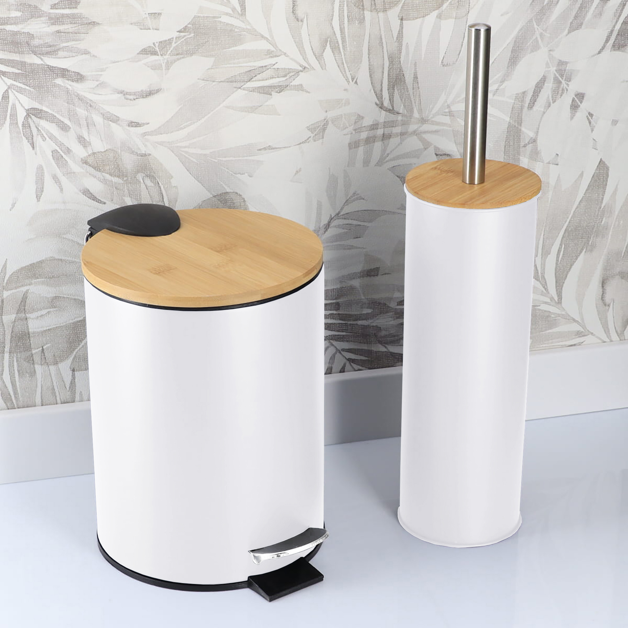White bathroom trash bin and toilet brush holder in a modern bathroom with a patterned wall background