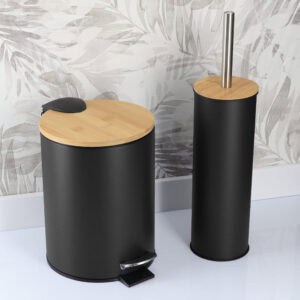 Black bathroom trash bin and toilet brush holder in modern bathroom with patterned wall background