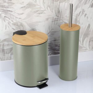 Green bathroom trash bin and toilet brush holder in a bathroom with patterned wall background