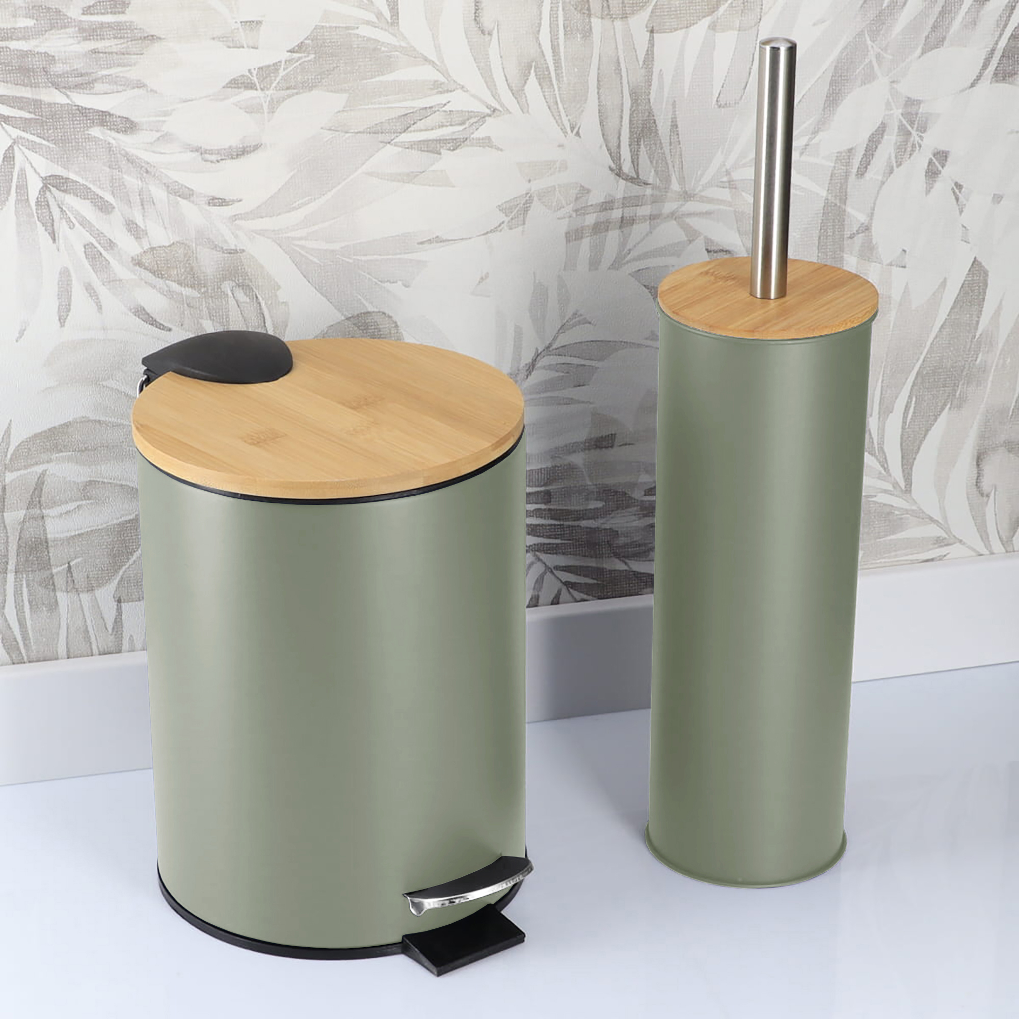 Green bathroom trash bin and toilet brush holder in a bathroom with patterned wall background