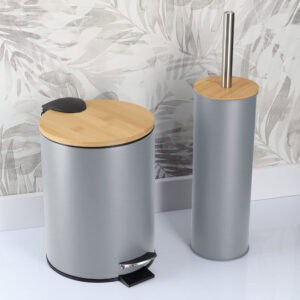 Gray bathroom trash bin and toilet brush holder in a bathroom with patterned wall background
