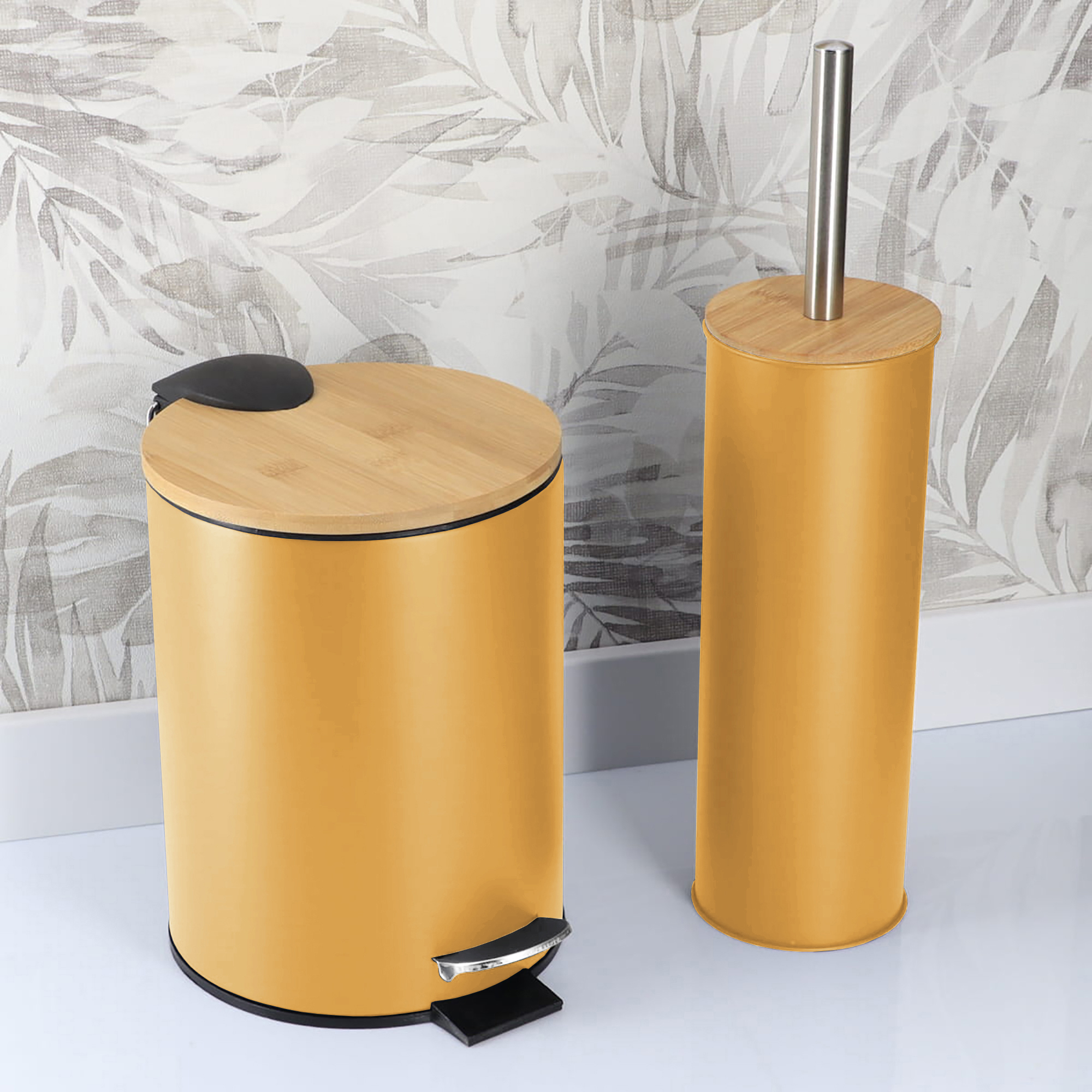 Mustard yellow bathroom trash bin and toilet brush holder in a bathroom with patterned wall background