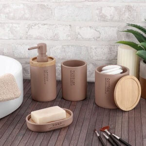 Cappuccino polyresin bathroom accessories with bamboo accents arranged near tub and bathroom counter