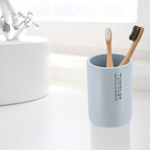 Toothbrush holder tumbler cup in bright modern bathroom setup