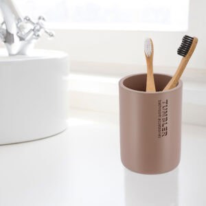 Toothbrush holder tumbler cup in bright modern bathroom setup