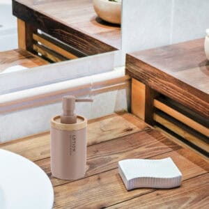 Matte cappuccino soap dispenser on rustic wood countertop with mirror