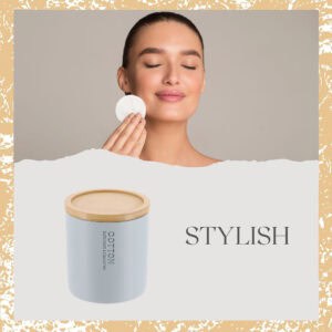 Woman using cotton pad with jar below