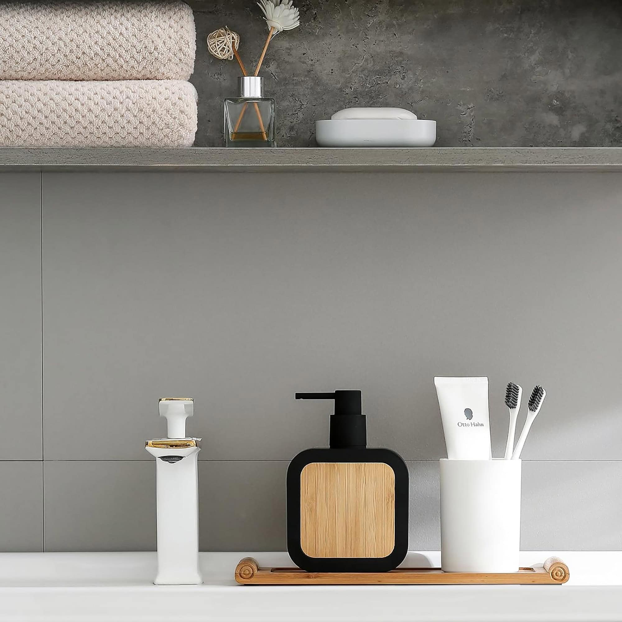 Soap dispenser in use by sink with matching accessories