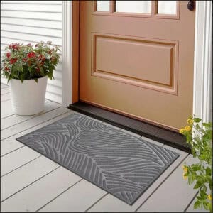 Gray wave doormat placed at entry door with flowers on porch