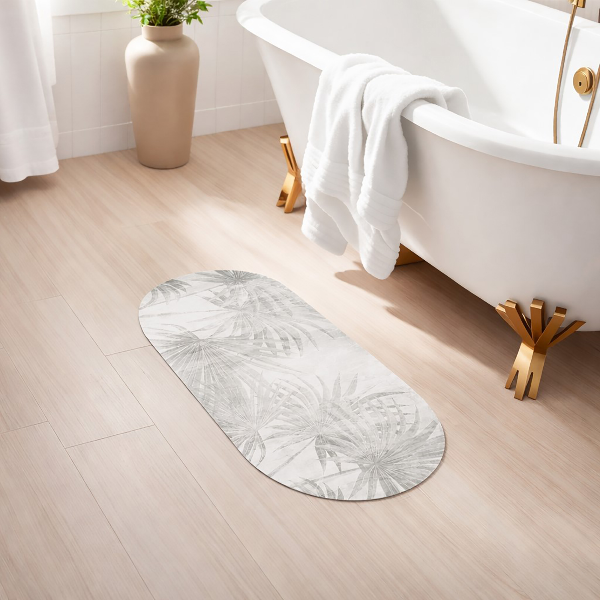 Oval palm leaf runner mat placed beside a freestanding bathtub in a bright, modern bathroom setting