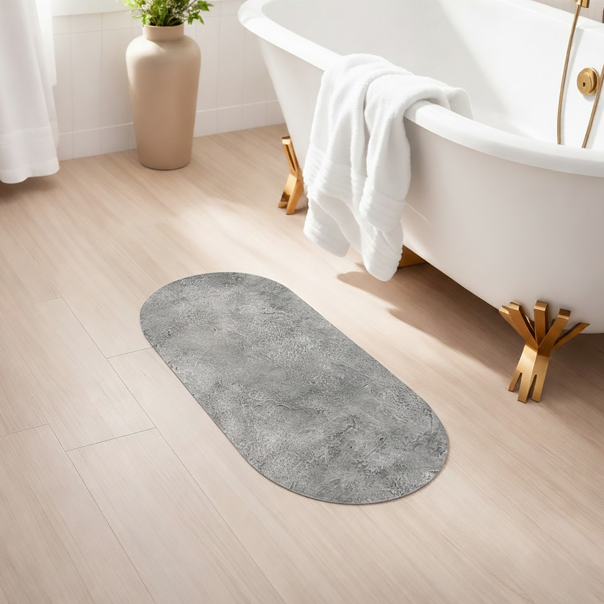 Stone-texture oval mat beside bathtub on light wood floor, creating a clean, urban-inspired look
