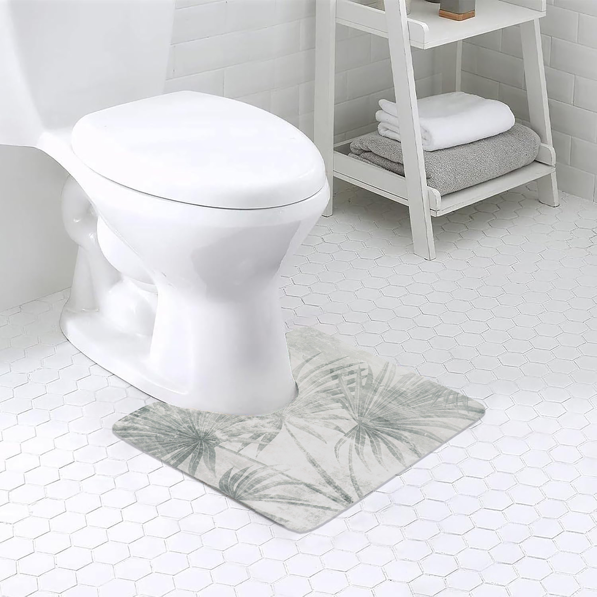 Palm Breeze contour mat placed around toilet base on white tile floor, adding a soft decorative touch