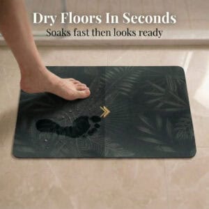 Foot stepping on Tropical Night bath mat showing "Dry Floors In Seconds" with water droplets