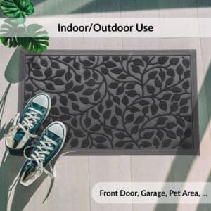 Black doormat for indoor outdoor use shown near shoes and plants
