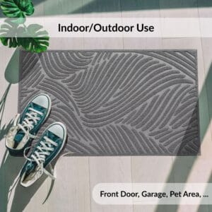 Gray wave-pattern doormat shown outdoors near shoes and plants