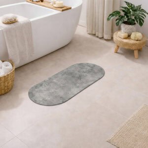 Urban Concrete oval bath mat runner styled in minimalist bathroom with freestanding tub and plants